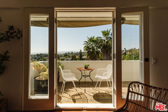 a balcony with table and chairs