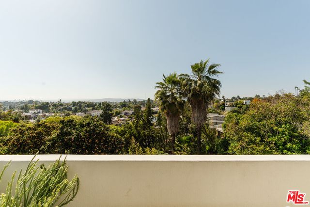 a balcony view with a potted plant on a table