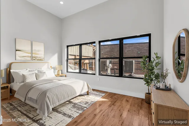 a spacious bedroom with a bed and a large window