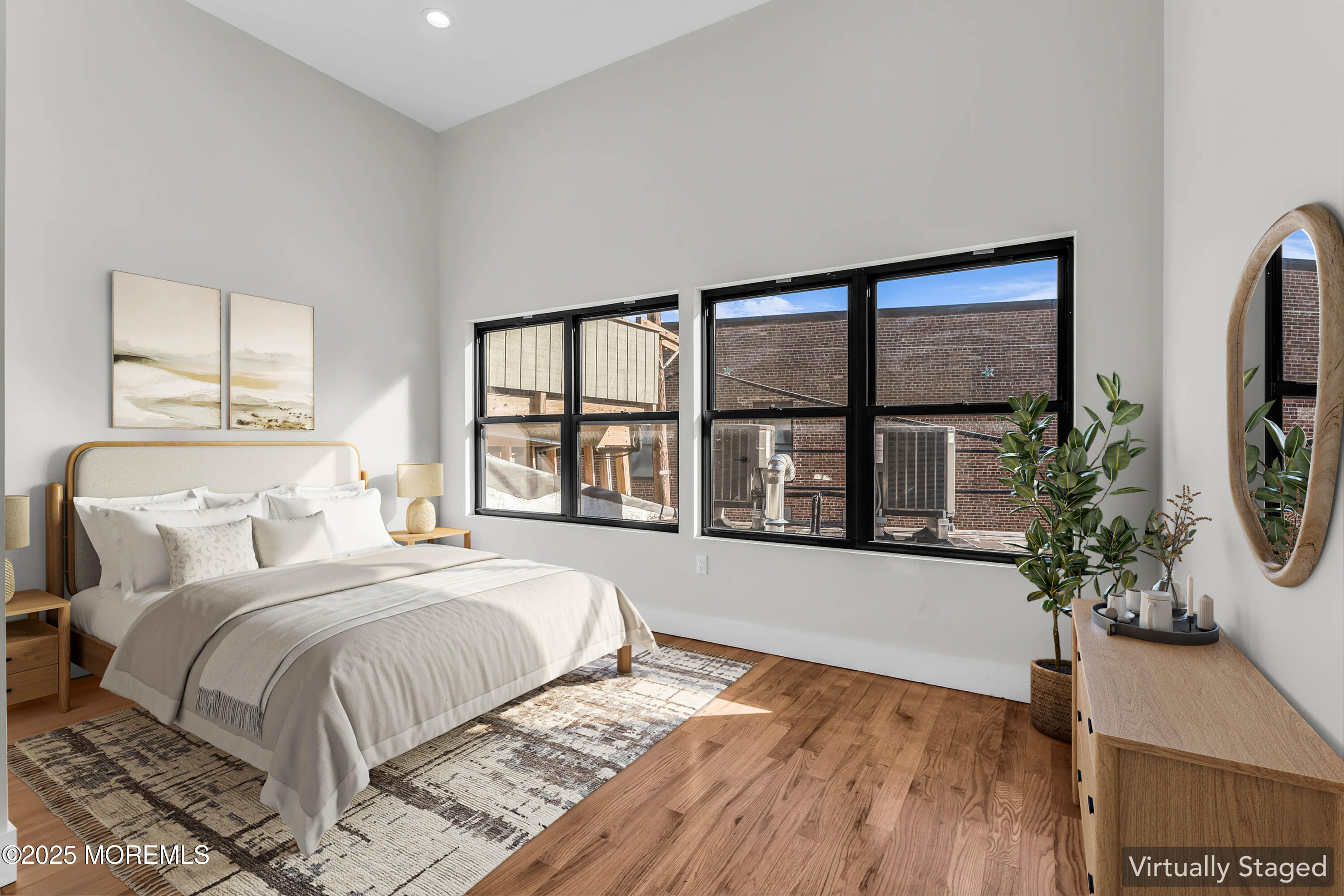 a spacious bedroom with a bed and a large window