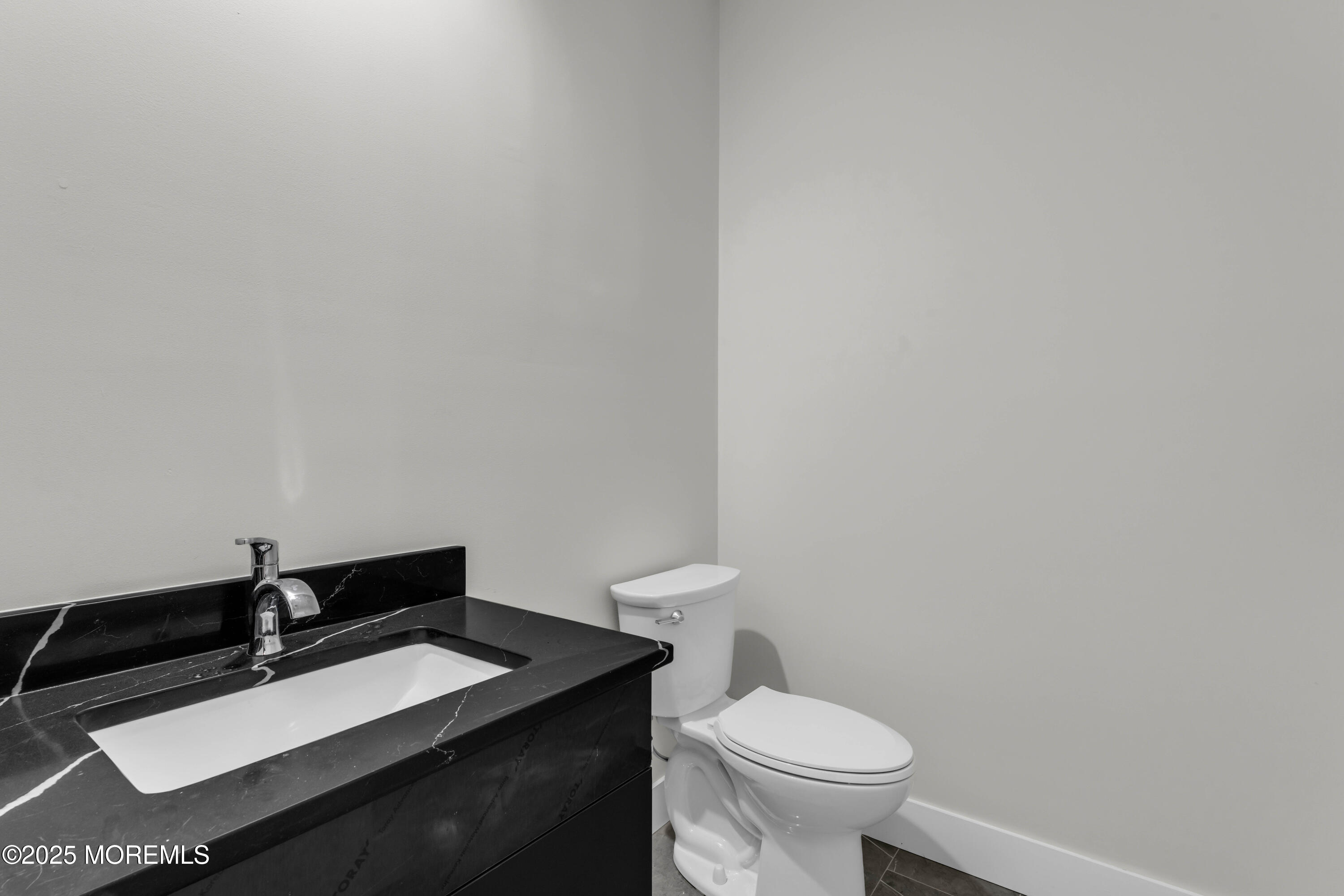7 Broad Street, Unit 3 Red Bank, NJ 07701 - Photo 11 of 18 a bathroom with a granite countertop toilet and sink