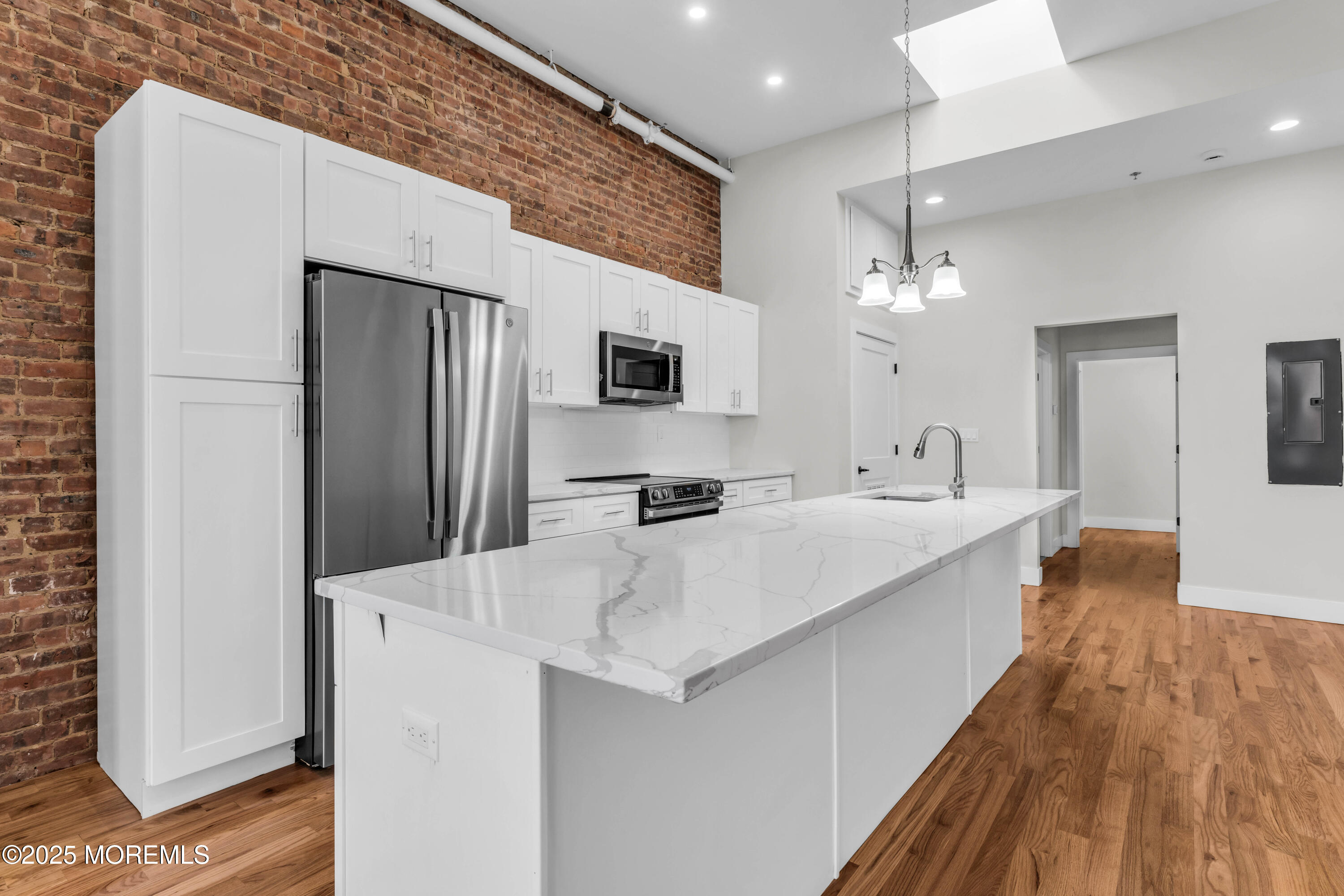 7 Broad Street, Unit 3 Red Bank, NJ 07701 - Photo 6 of 18 a large white kitchen with a large window