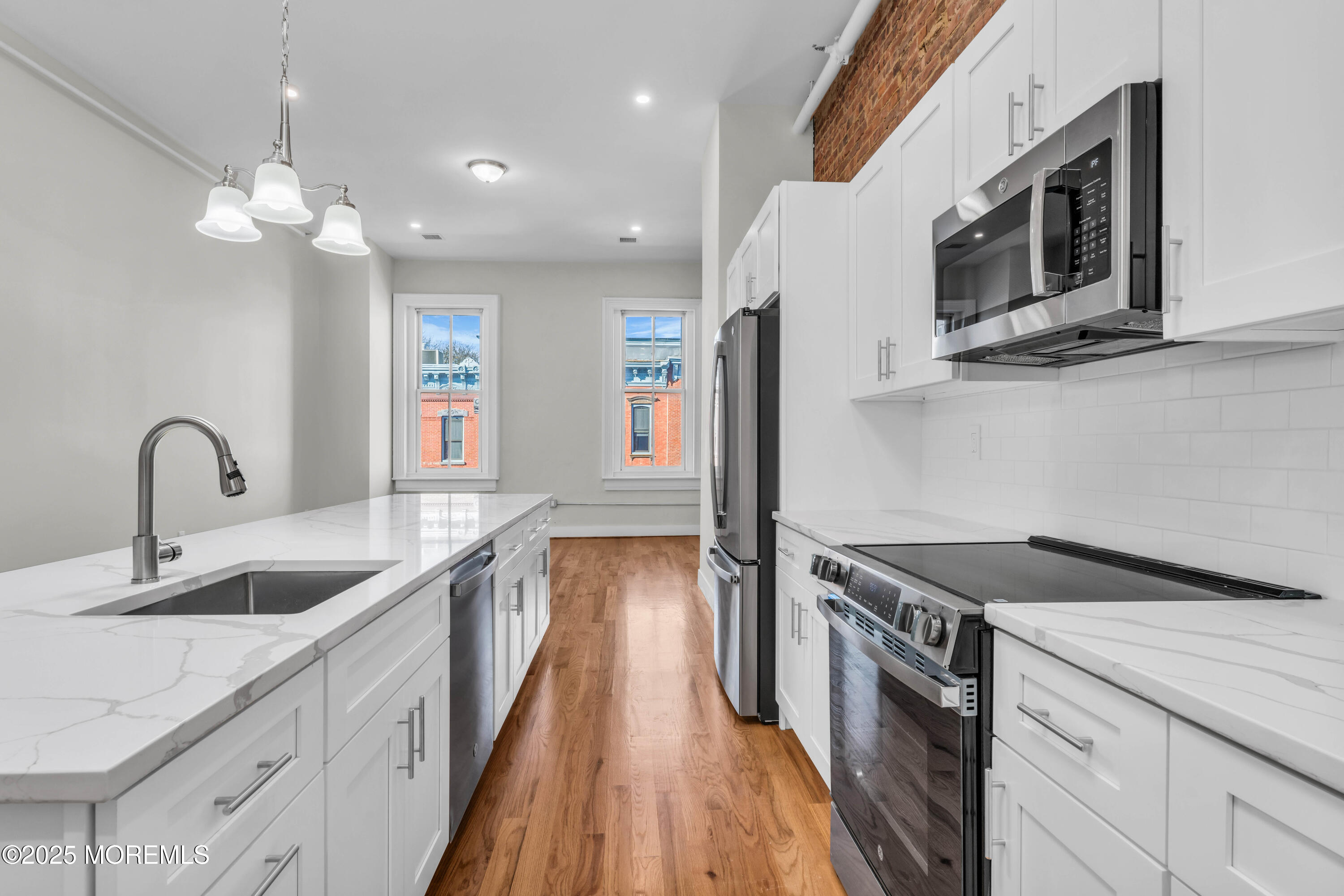 7 Broad Street, Unit 3 Red Bank, NJ 07701 - Photo 7 of 18 a kitchen with stainless steel appliances granite countertop a sink and a stove