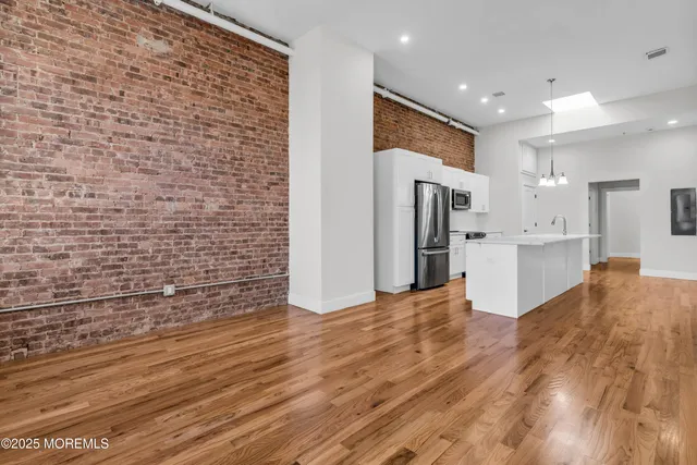 a view of kitchen with refrigerator and cabinets