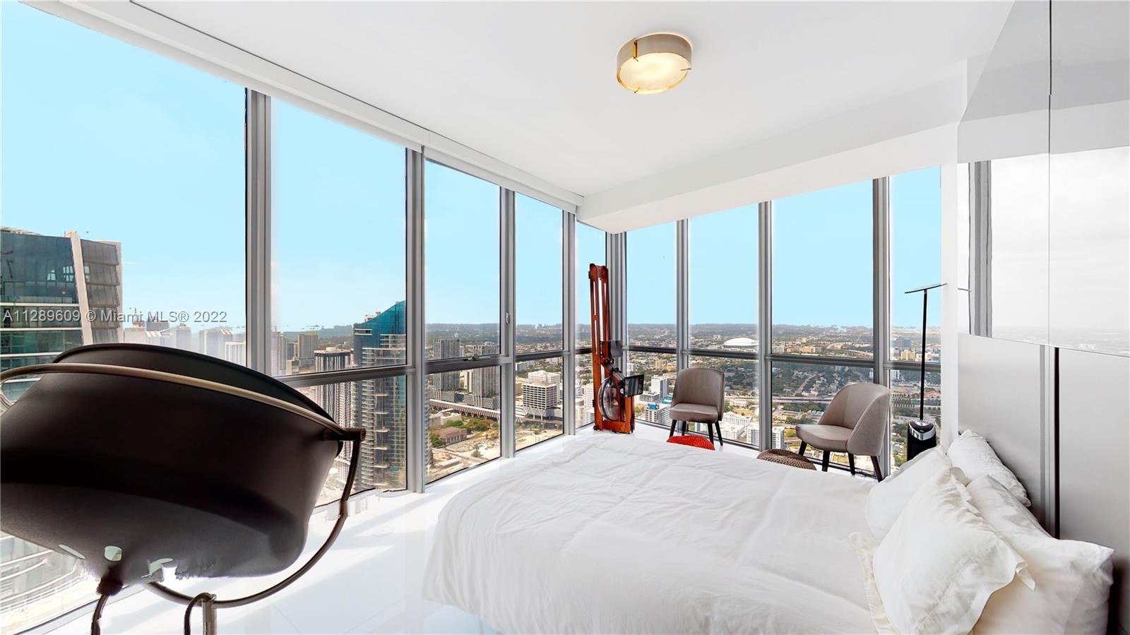 1100 Biscayne Boulevard, Unit 6307 Miami, FL 33132 - Photo 11 of 19 a bedroom with a bed and large window