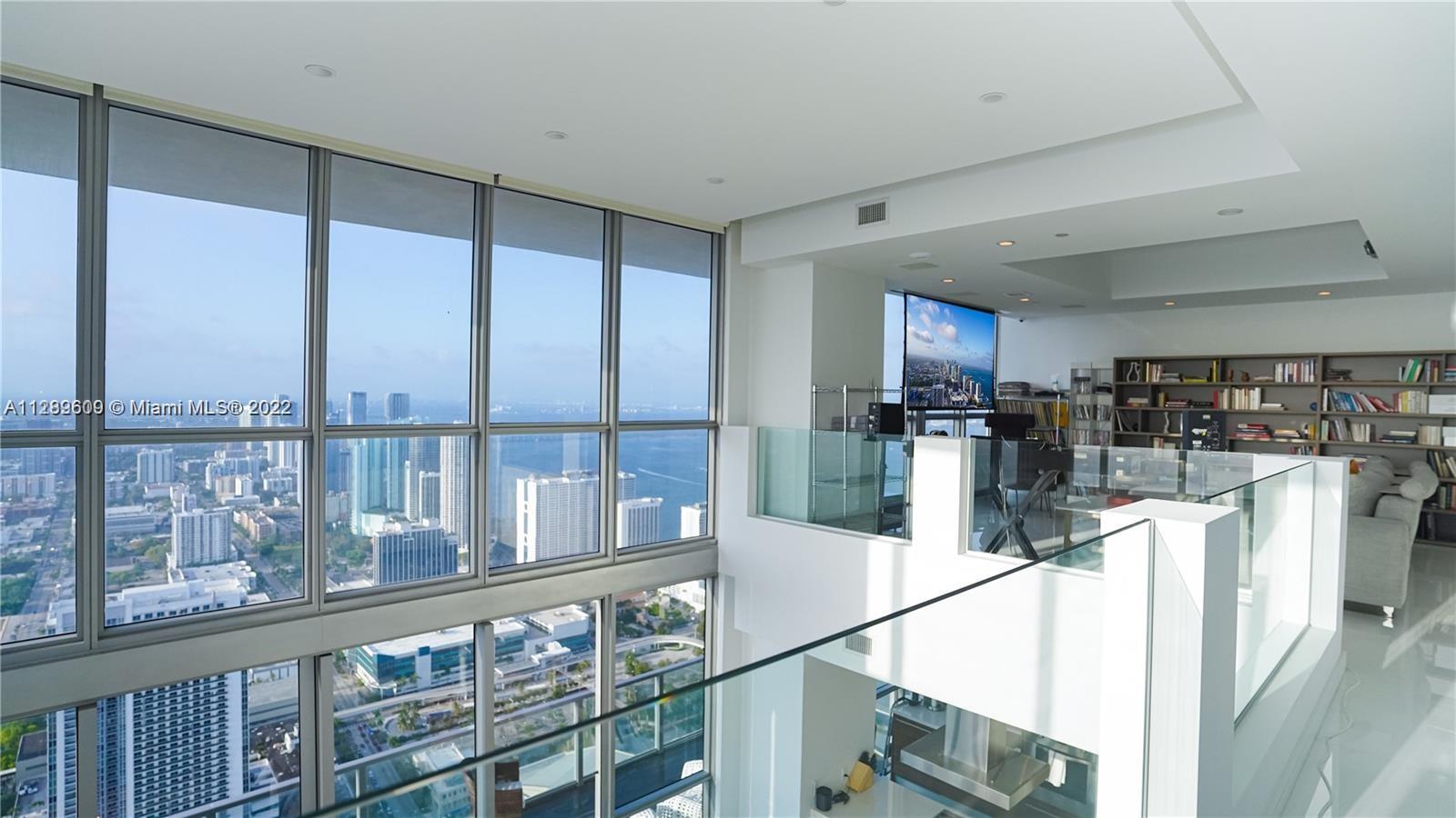 1100 Biscayne Boulevard, Unit 6307 Miami, FL 33132 - Photo 3 of 19 a open kitchen with stainless steel appliances granite countertop a refrigerator a stove and a wooden cabinets