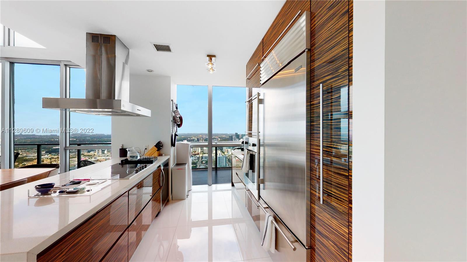 1100 Biscayne Boulevard, Unit 6307 Miami, FL 33132 - Photo 4 of 19 a kitchen with stainless steel appliances a sink stove and refrigerator