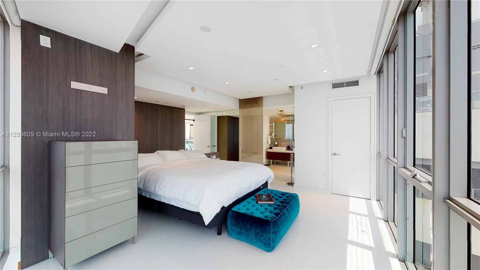 1100 Biscayne Boulevard, Unit 6307 Miami, FL 33132 - Photo 9 of 19 a spacious bedroom with a bed and a dresser