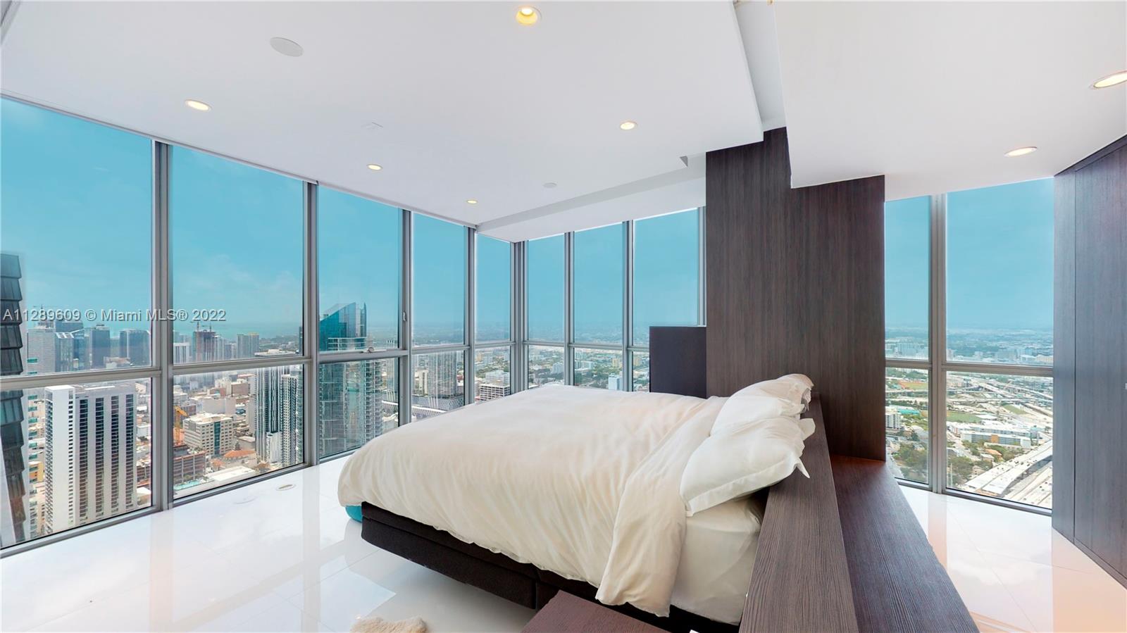 1100 Biscayne Boulevard, Unit 6307 Miami, FL 33132 - Photo 10 of 19 a bedroom with a large bed and a large window