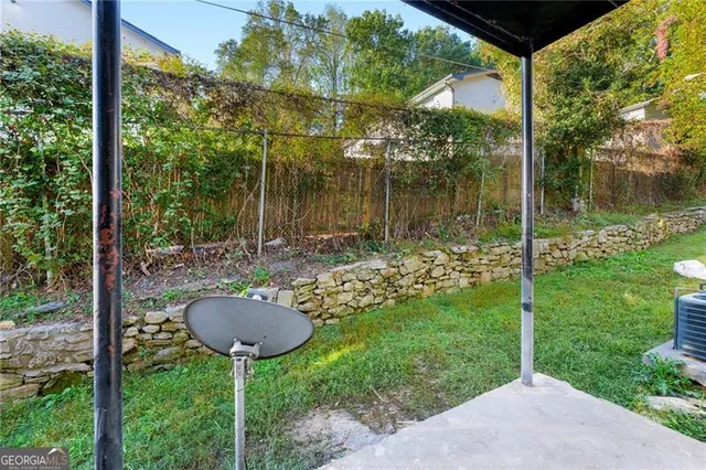 a backyard of a house with table and chairs