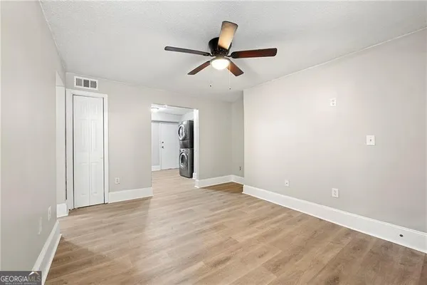 a view of an empty room and wooden floor