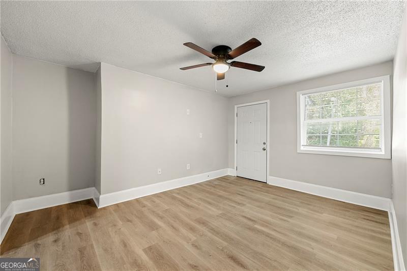 156 Fairfield Place Northwest Atlanta, GA 30314 - Photo 5 of 17 a view of empty room with wooden floor and fan