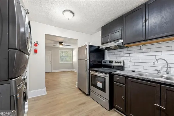 a kitchen with stainless steel appliances granite countertop a stove and a refrigerator