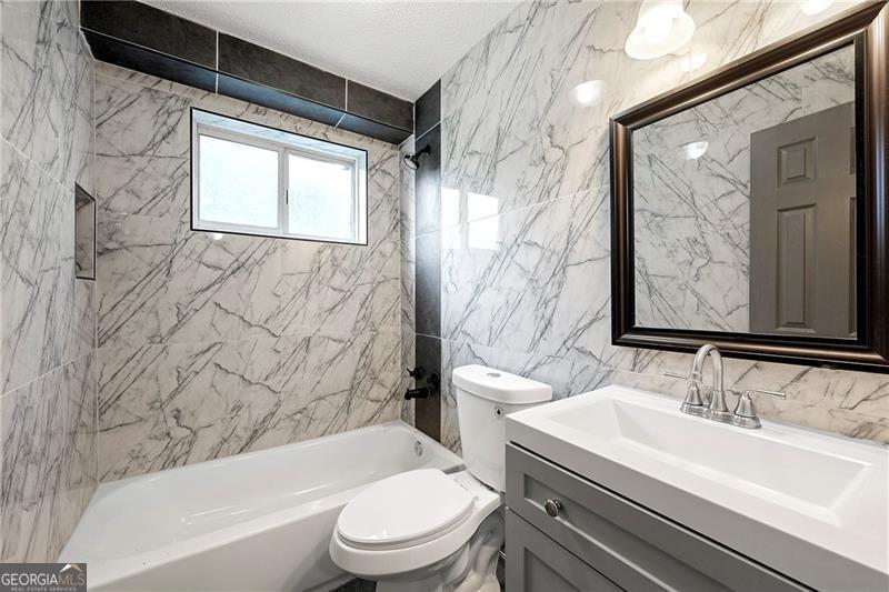 156 Fairfield Place Northwest Atlanta, GA 30314 - Photo 10 of 17 a bathroom with a sink a toilet and a bathtub
