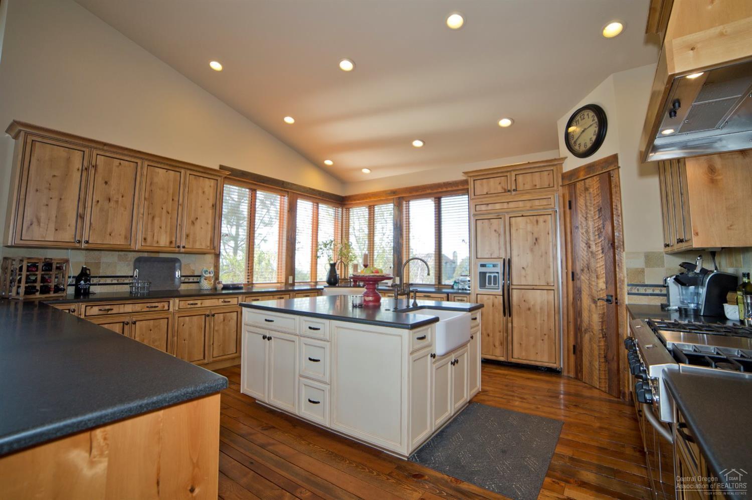 16448 South W Brasada Ranch Road Powell Butte, OR 97753 - Photo 7 of 25 a kitchen with stainless steel appliances granite countertop a stove a sink a refrigerator and cabinets