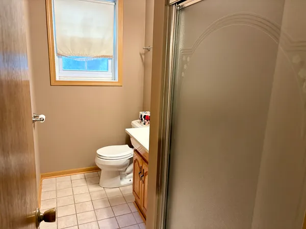 a bathroom with a toilet and a shower