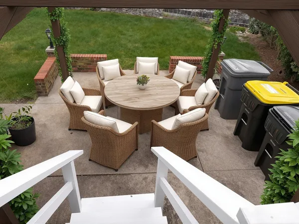 a view of a patio with table and chairs potted plants with floor to ceiling window