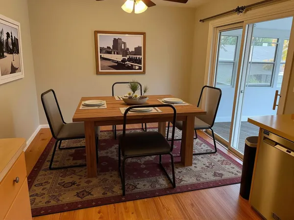 a view of a dining room with furniture and wooden floor