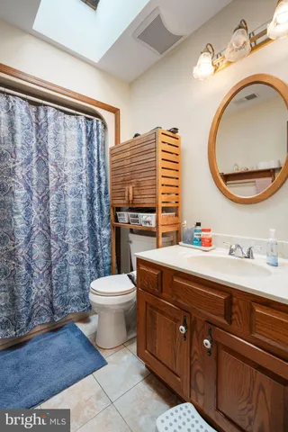 a bathroom with a toilet a sink and a mirror