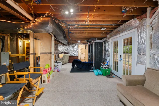 a living room with furniture and potted plants