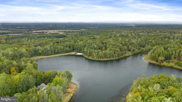 an aerial view of a house with a lake view