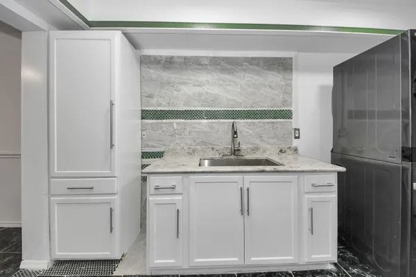 a bathroom with a granite countertop sink and a mirror