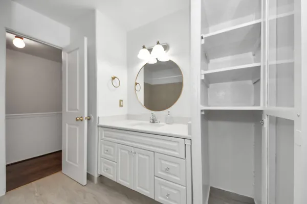 a bathroom with a sink vanity and mirror