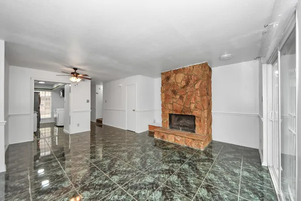 wooden floor in an empty room with a fireplace