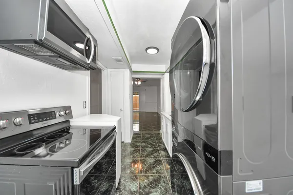 a view of a hallway with washer and dryer