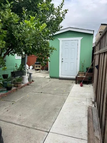 a view of backyard with wheel chair and potted plants