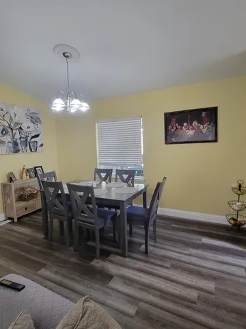 a view of a dining room with furniture and chandelier