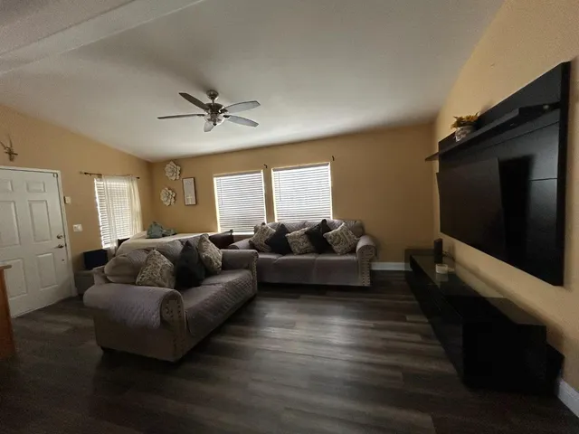 a living room with furniture and a flat screen tv