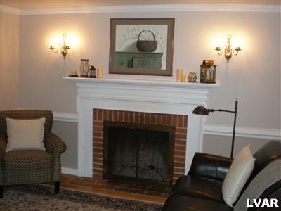 945 Birch Road Hellertown, PA 18055 - Photo 11 of 24 Spacious family room with wood burning fireplace, chair rail, hardwood floors.