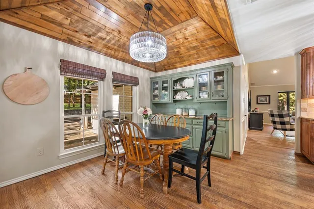 a dining room with furniture wooden floor and a rug