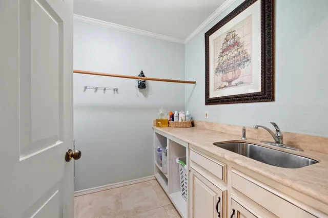 a view of a kitchen with cabinets and a sink