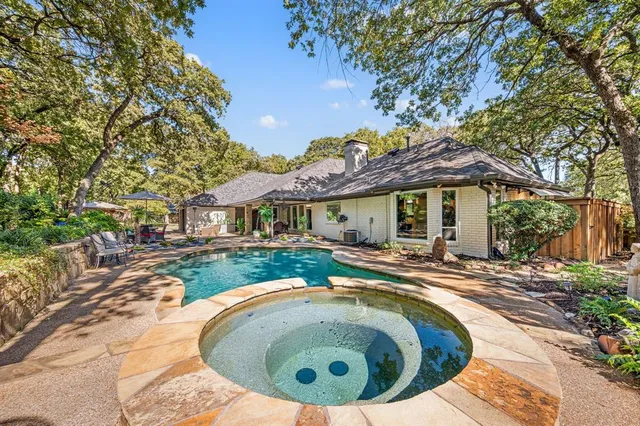 a view of a house with swimming pool and sitting area