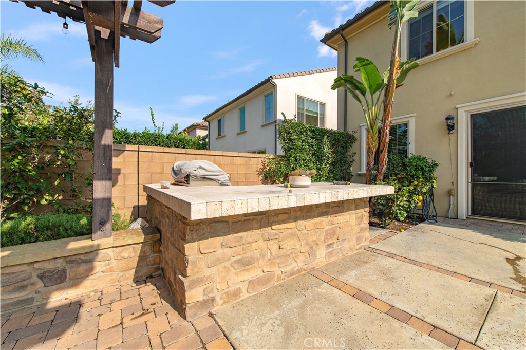 166 Desert Bloom Irvine, CA 92618 - Photo 18 of 36 a view of a house with backyard and a tree
