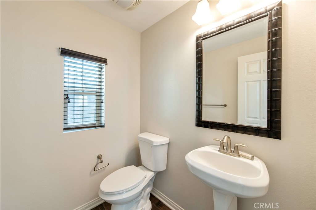 166 Desert Bloom Irvine, CA 92618 - Photo 22 of 36 a bathroom with a toilet sink and mirror