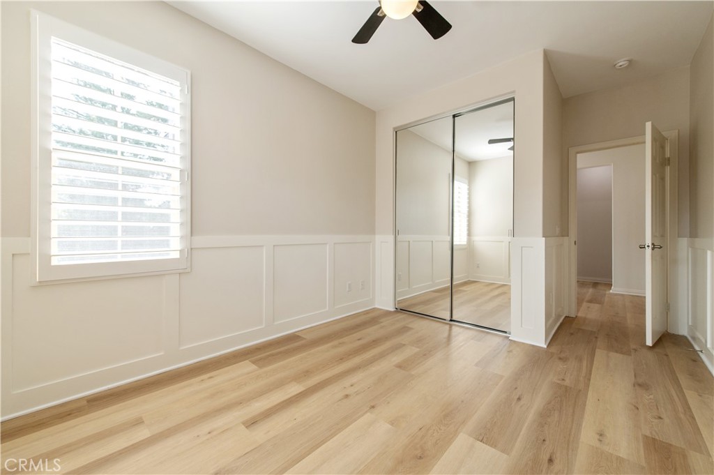 166 Desert Bloom Irvine, CA 92618 - Photo 26 of 36 a view of an empty room with wooden floor and a window