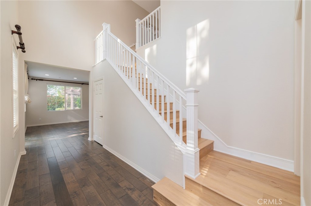 166 Desert Bloom Irvine, CA 92618 - Photo 3 of 36 a view of entryway and hall with wooden floor