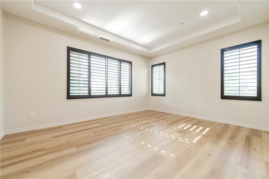 166 Desert Bloom Irvine, CA 92618 - Photo 31 of 36 a view of an empty room with wooden floor and a window