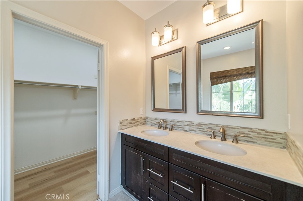 166 Desert Bloom Irvine, CA 92618 - Photo 33 of 36 a bathroom with a sink a vanity and a mirror