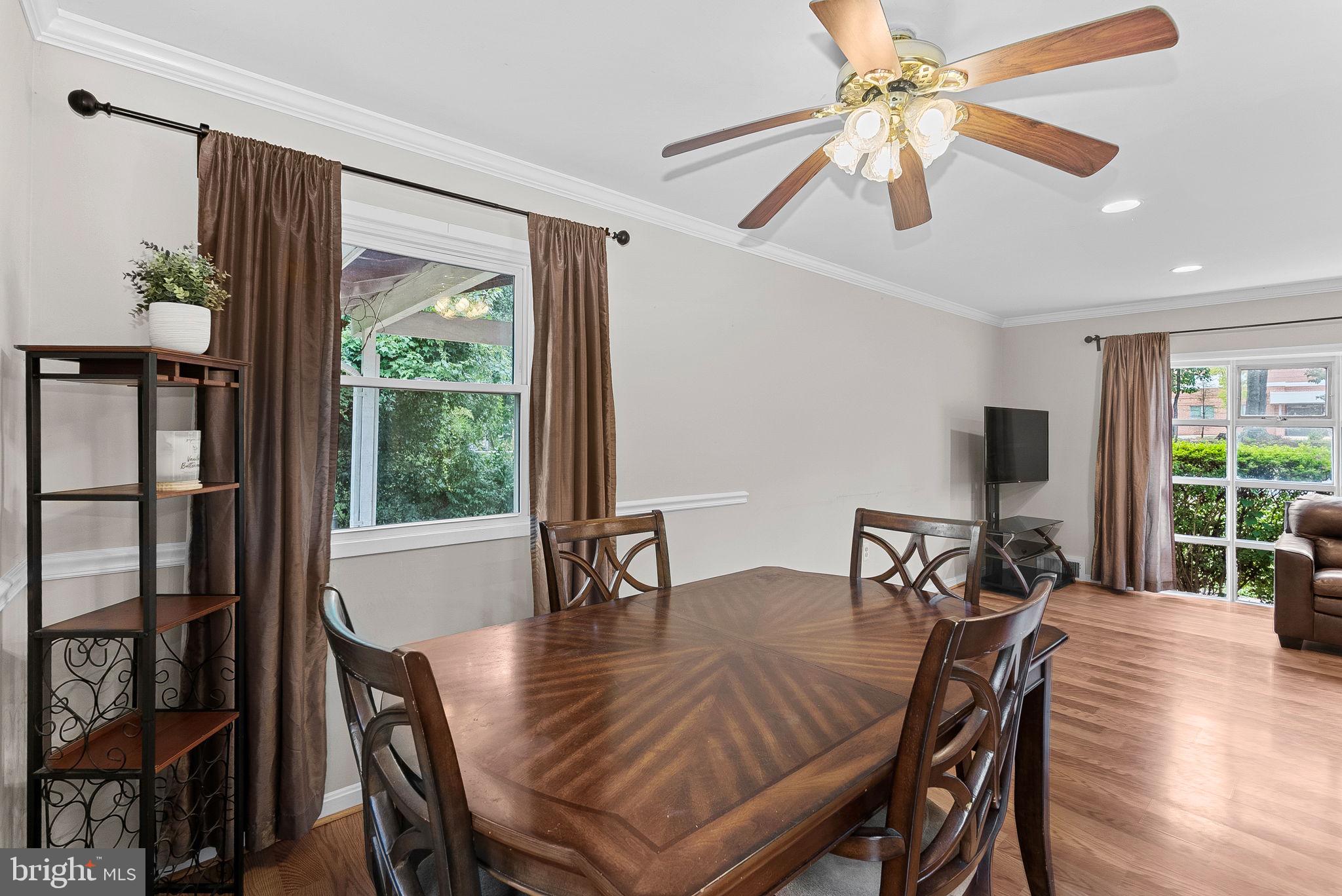 6313 Bardu Avenue Springfield, VA 22152 - Photo 11 of 26 a view of a dining room with furniture window and wooden floor