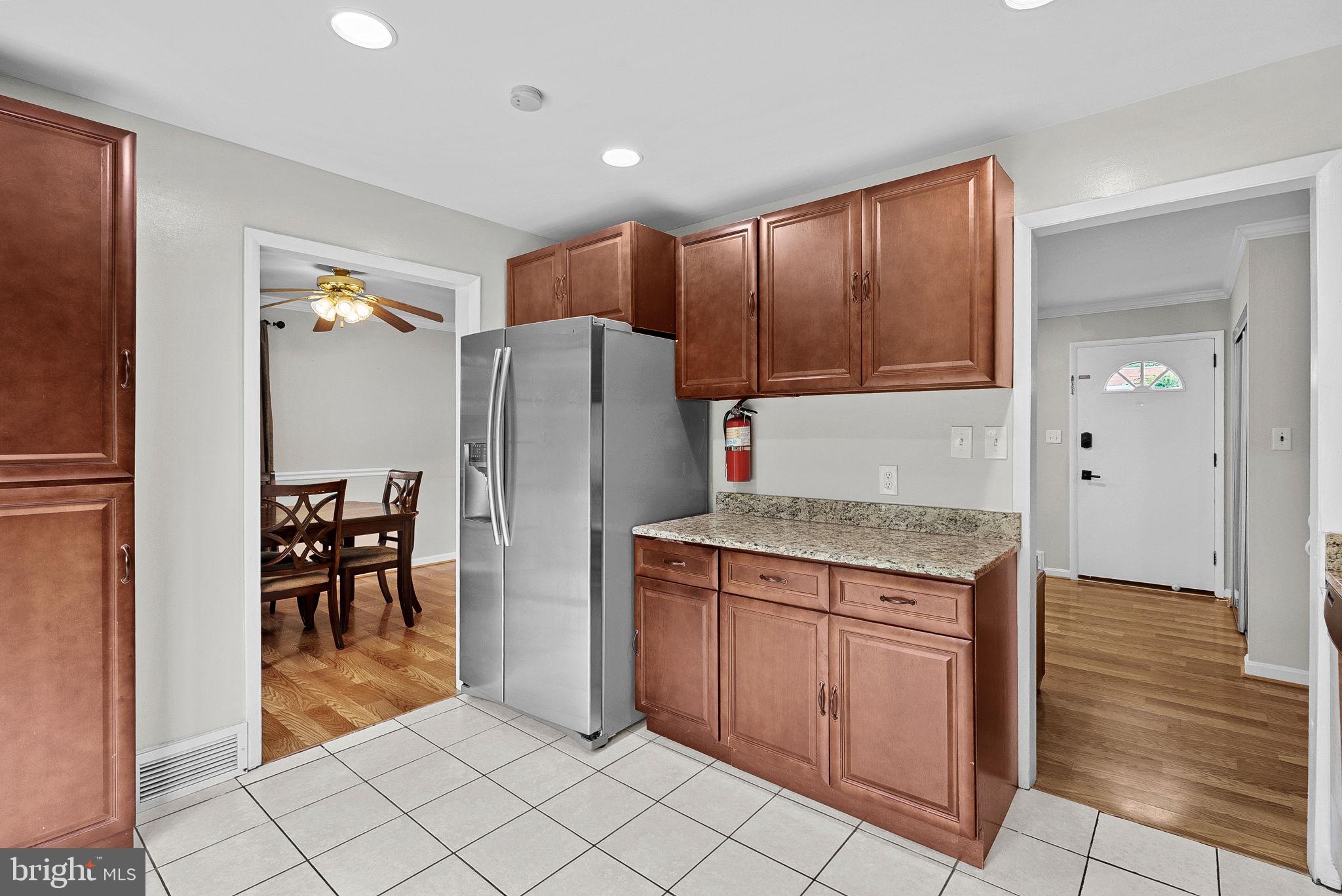 6313 Bardu Avenue Springfield, VA 22152 - Photo 13 of 26 a kitchen with granite countertop a refrigerator and a sink