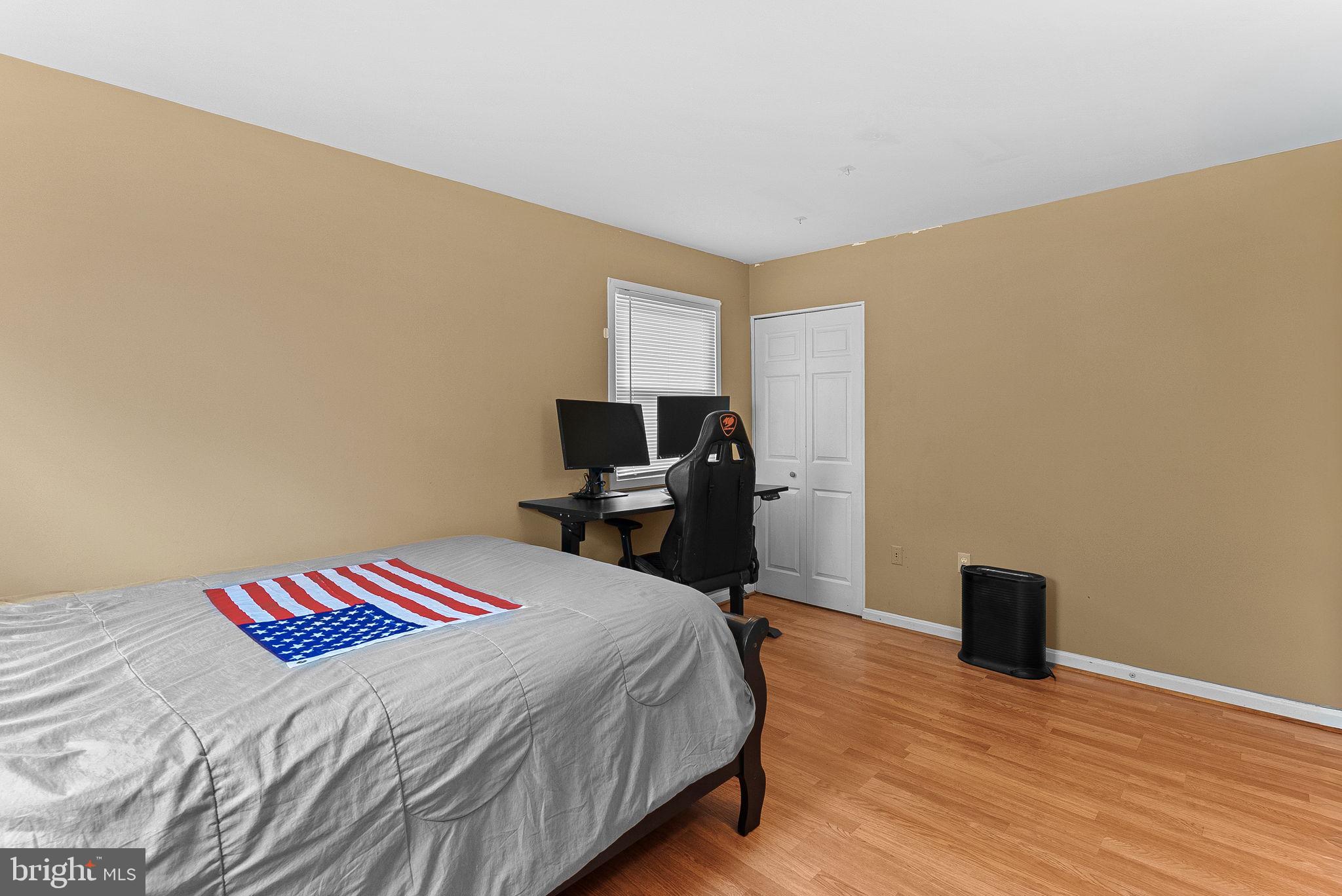 6313 Bardu Avenue Springfield, VA 22152 - Photo 16 of 26 a bedroom with a bed and wooden floor