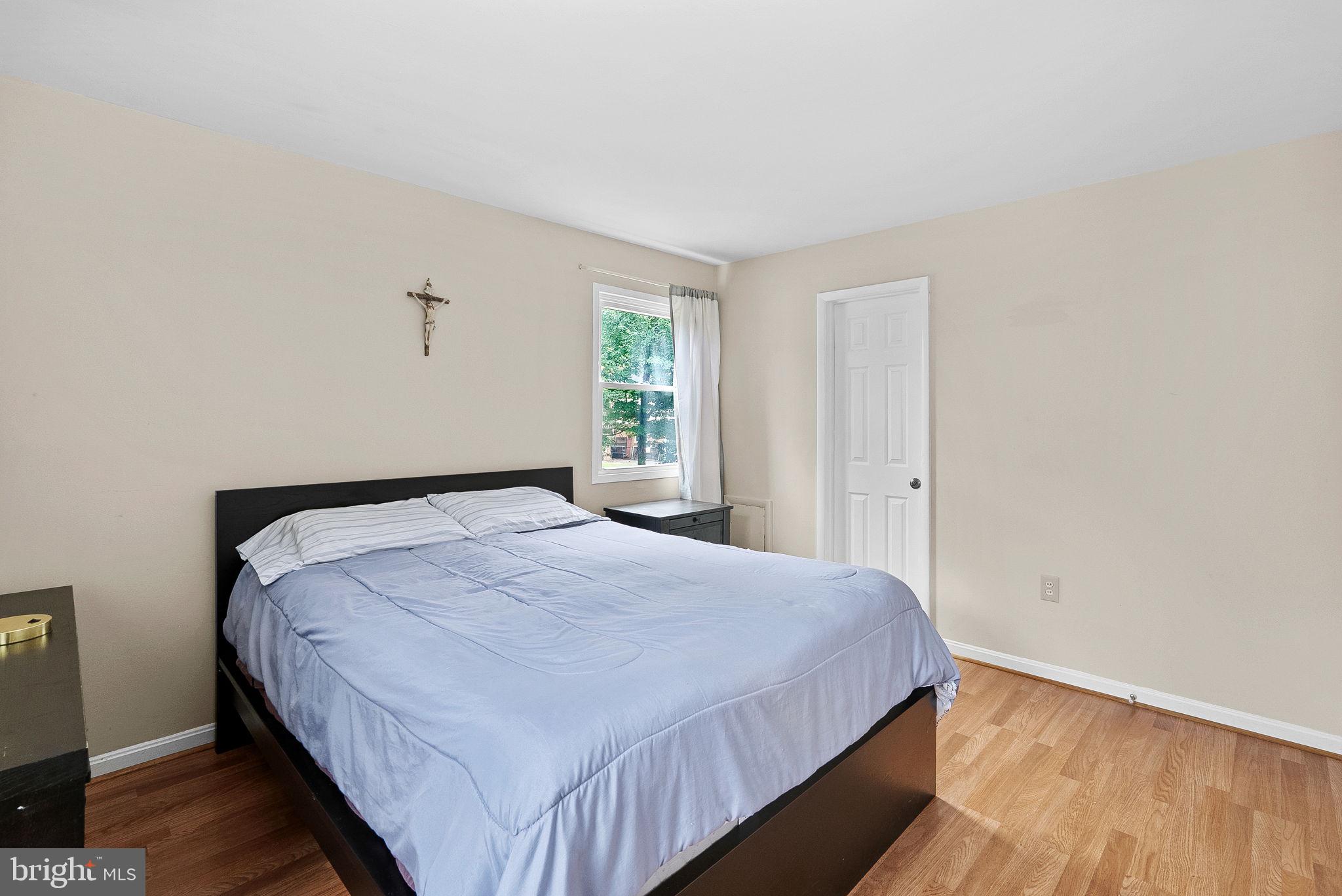 6313 Bardu Avenue Springfield, VA 22152 - Photo 19 of 26 a bedroom with a bed and wooden floor