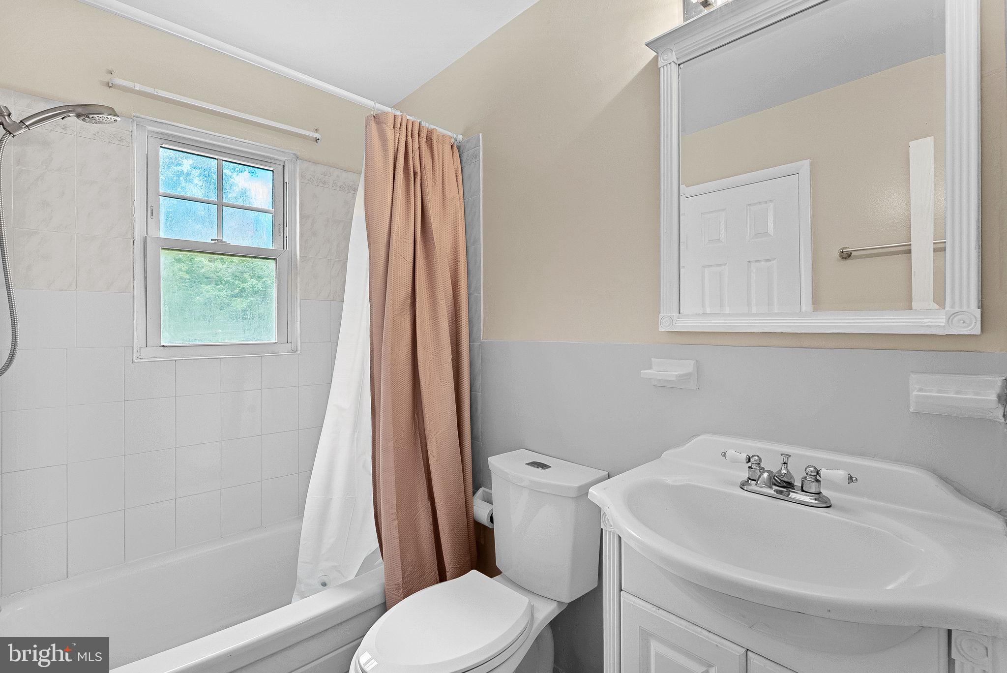 6313 Bardu Avenue Springfield, VA 22152 - Photo 20 of 26 a bathroom with a sink toilet and shower