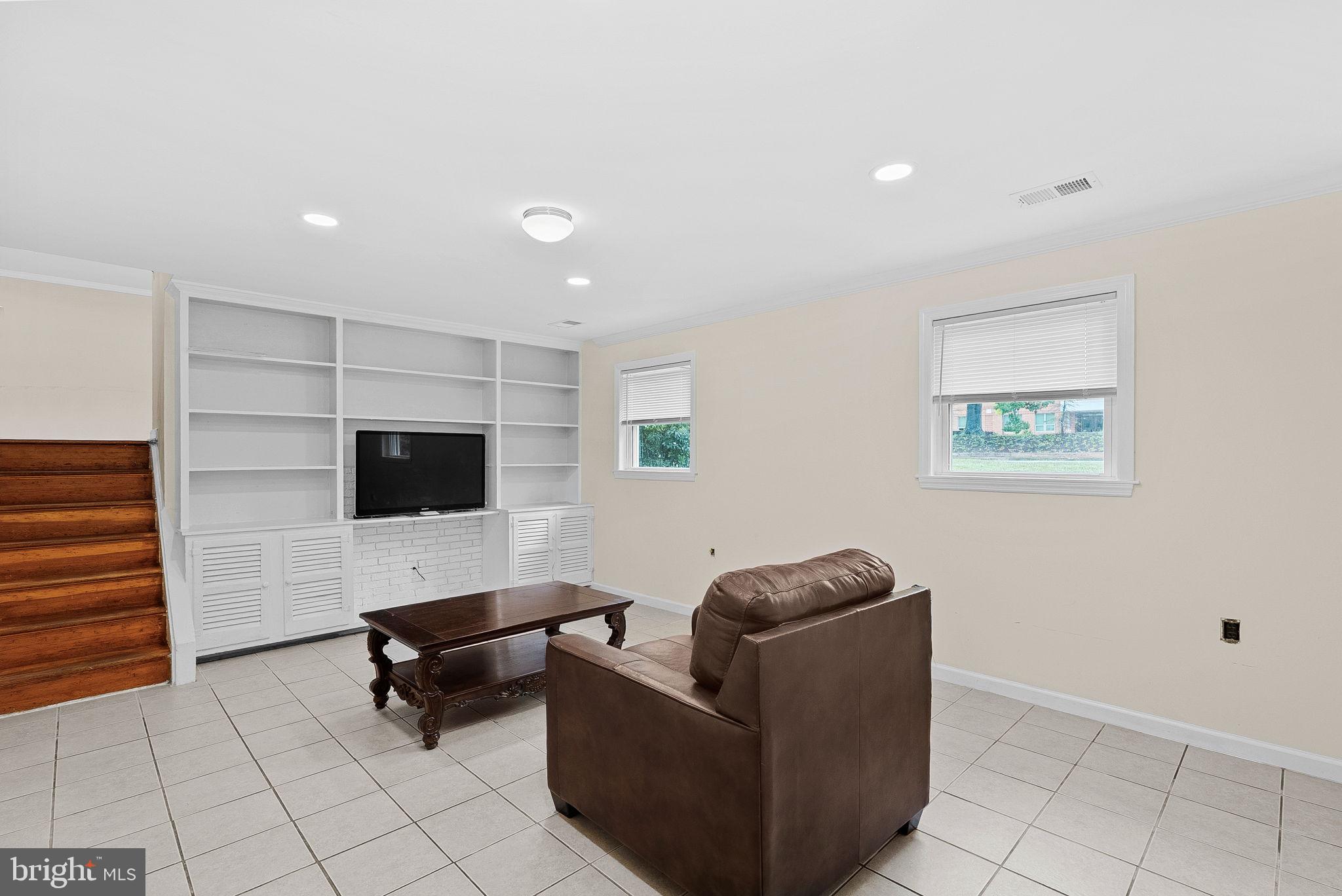6313 Bardu Avenue Springfield, VA 22152 - Photo 21 of 26 a living room with furniture and a flat screen tv