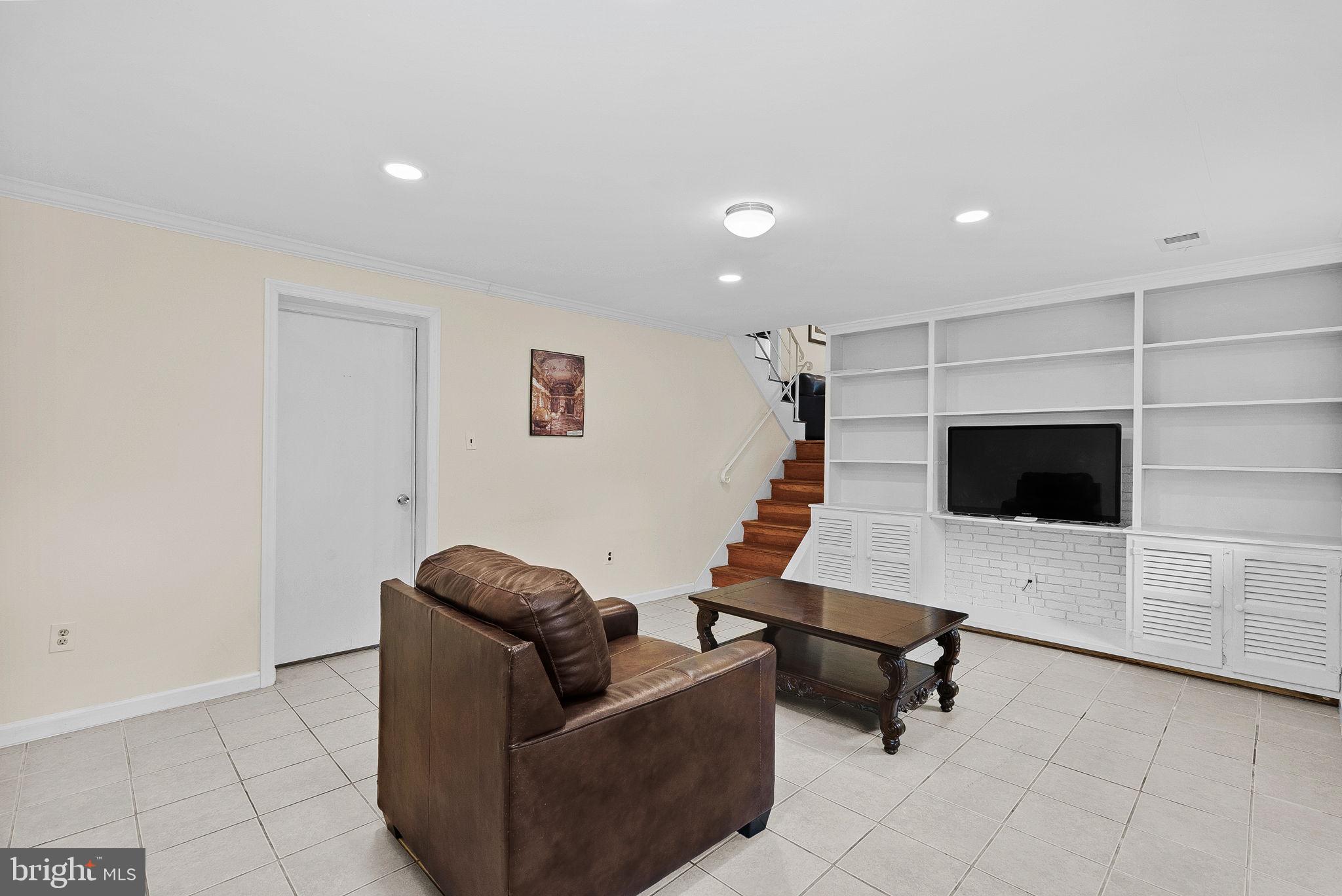 6313 Bardu Avenue Springfield, VA 22152 - Photo 22 of 26 a living room with furniture and a flat screen tv