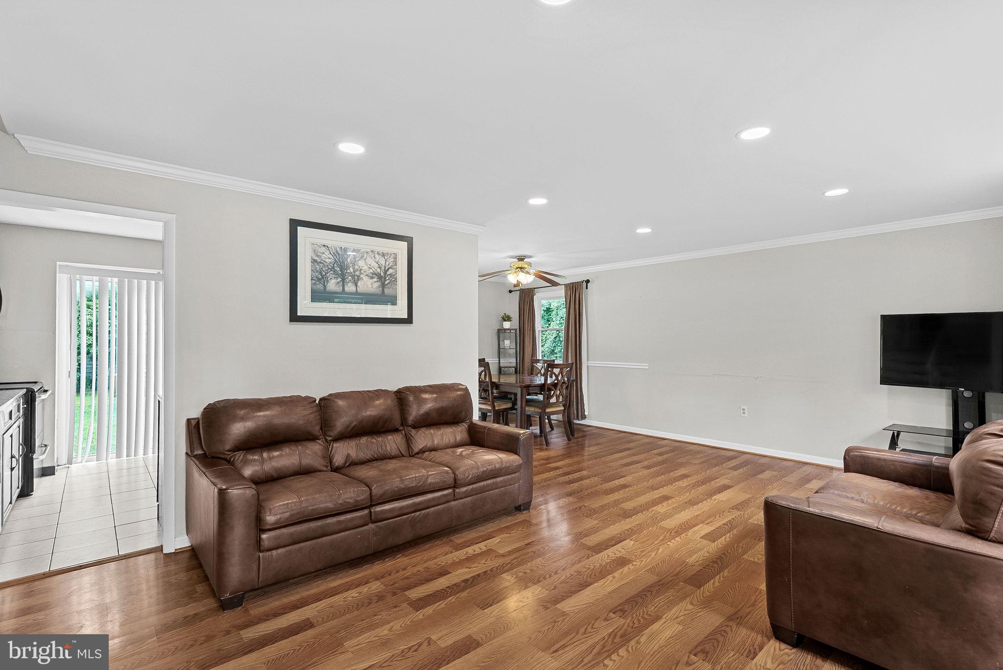 6313 Bardu Avenue Springfield, VA 22152 - Photo 4 of 26 a living room with furniture and a flat screen tv